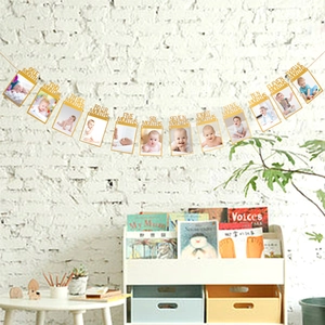 Glitter gold baby first birthday photo banner showing 12 monthly growth picture frames