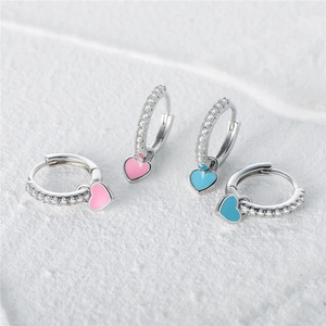 Detail of silver heart earrings with pink and blue enamel and sparkling pavé crystals