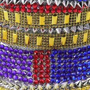 Macro detail of rhinestone captain hat with silver studs and colorful gemstone crystals
