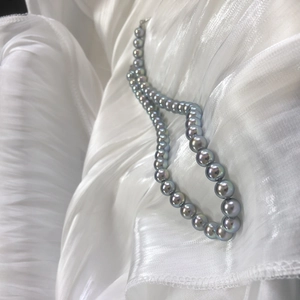 Silver-blue aurora pearl necklace with S925 sterling silver clasp on silk background