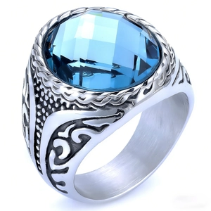 Macro detail of men's vintage steel ring featuring a faceted blue oval gemstone inlay