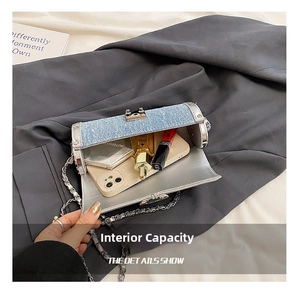 Detail showing the internal capacity of the silver mini cylinder bag with silver hardware