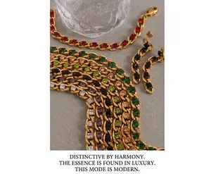 Close-up of gold Cuban chain necklace and earrings with colorful zircon gemstones