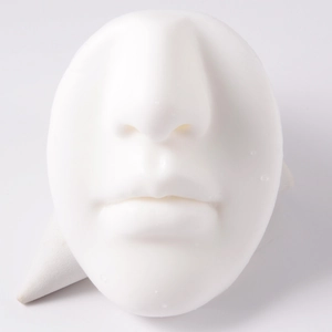 Macro shot of a white silicone human face model for lip piercing and cosmetic practice