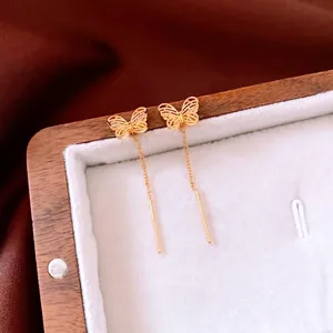 18K gold-plated butterfly threader earrings with delicate tassels on a velvet jewelry box
