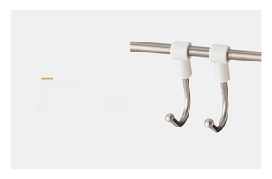 Macro detail of stainless steel S-hooks with white clips for kitchen bar storage