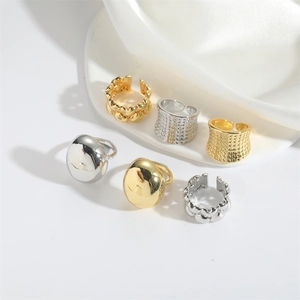 Minimalist gold and silver open rings set with polished domes and heart chain designs