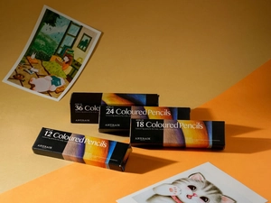 Artistic display of 12, 18, 24, and 36 count colored pencil sets with illustration cards