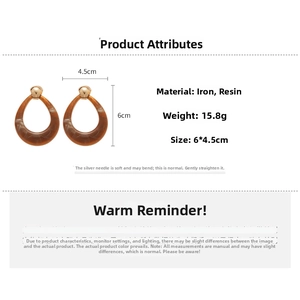 Detail view of resin teardrop earrings with brown marble texture and size dimensions