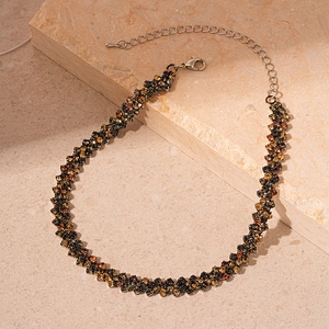 Close-up of contrast color crystal necklace with geometric paving and lobster clasp