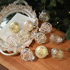 Set of clear 6cm Christmas balls with gold glitter and mesh filler hanging on tree