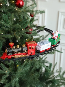 Electric Christmas train circling a green tree with Santa and Merry Christmas locomotive
