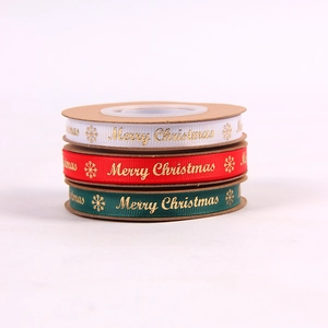 Three rolls of Christmas ribbons in red green and white with gold Merry Christmas print