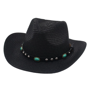 Detail of black straw cowboy hat featuring turquoise studs and silver rivets on leather band