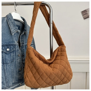 Close-up of brown corduroy tote bag with diamond quilted pattern on a hanger