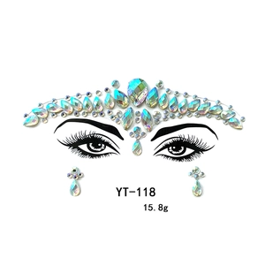 Detailed view of holographic acrylic face gems and rhinestone stickers for party makeup looks.
