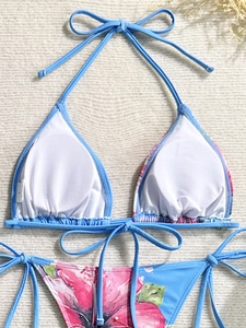 Detailed close-up of sky blue bikini top lining with removable padding and S size tag