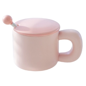 Pink ceramic mug with matching lid and spherical handle spoon on a clean white background