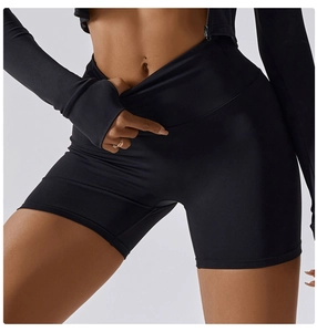 Detailed close-up of high-waisted black yoga shorts with tummy control and seamless texture
