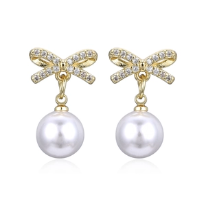 Elegant gold bow earrings with white pearl pendants and sparkling diamond accents