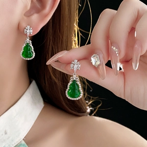 Elegant model wearing green gourd-shaped earrings with white zircon accents in silver