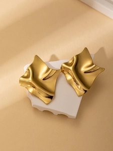 Detailed view of 18K gold plated titanium steel earrings with irregular wave design