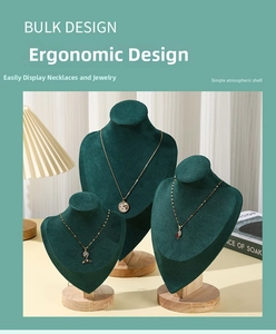 Macro detail of emerald green velvet necklace display stands with solid wood round bases