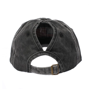 Detail of adjustable brass buckle and ponytail hole on washed cotton baseball cap