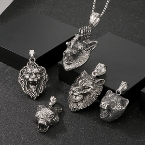 Detailed relief of vintage lion and wolf head pendants in punk stainless steel style