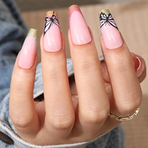 Close-up of long pink coffin nails with gold glitter and black butterfly art