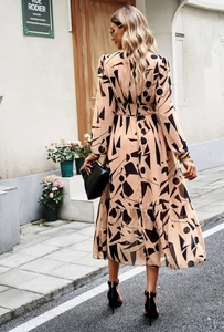 Back view of a long-sleeved floral midi dress with geometric patterns and ruffled hemline