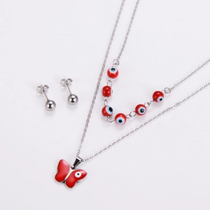 Detail view of double-layer stainless steel necklace and studs with red evil eye butterfly