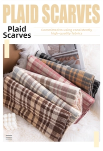 Detailed pile of thick vintage plaid scarves in various colors on soft white fur