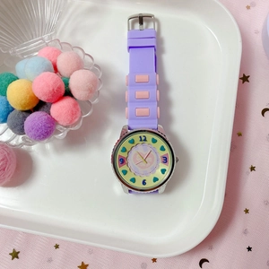 Detail of purple silicone kids watch with heart pattern and summer text on shell tray