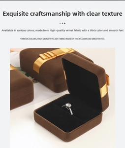 Macro view of brown velvet jewelry box with golden ribbon for rings and necklaces
