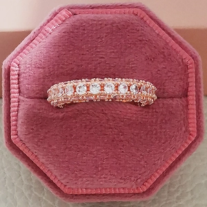 Detail of rose gold multi-row pavé ring with zircons in a velvet jewelry box