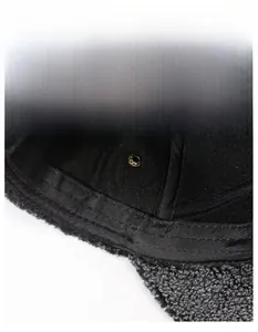 Detailed close-up of thickened inner sweatband and warm faux fur lining on winter hat