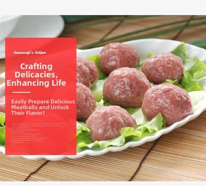 Fresh raw meatballs arranged on lettuce leaves in a white tray for cooking preparation