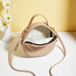 Minimalist beige semi-circle crossbody bag with geometric V-texture and zipper closure