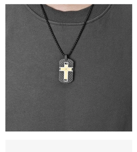 Detailed view of carbon fiber dog tag pendant with gold cross and small diamond inlay