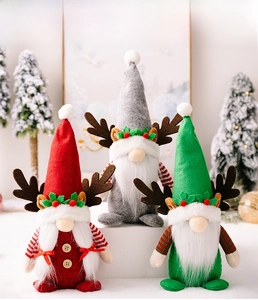 Three festive Christmas gnomes with reindeer antlers and holly leaf details on white blocks
