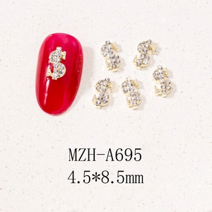 Detailed view of silver and gold dollar sign nail charms with sparkling rhinestones