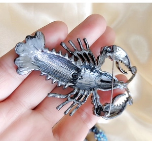 Detail view of the vintage silver lobster brooch back with secure metal pin clasp