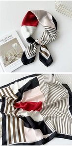 Detail view of square silk scarf with red, black, and white striped geometric pattern