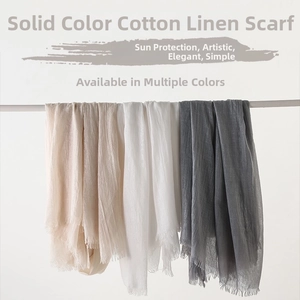 Detailed texture of solid cotton linen scarves with frayed edges in neutral colors