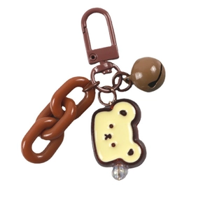 Brown metal carabiner with acrylic chain and cute bear head charm on white background