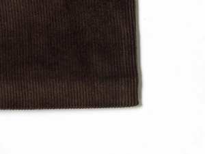 Close-up detail of dark brown corduroy fabric texture and fine ribbed pattern