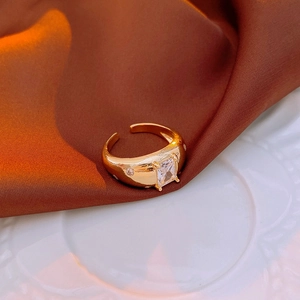 Macro detail of vintage gold open ring with square zircon stone and pave accents