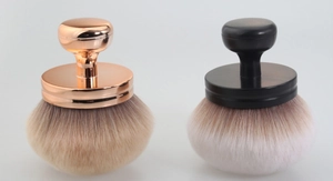 Detail view of large mushroom powder brushes in rose gold and matte black finishes