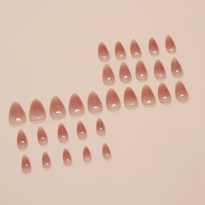 Glossy almond-shaped press-on nails with minimalist pink ombre gradient effect